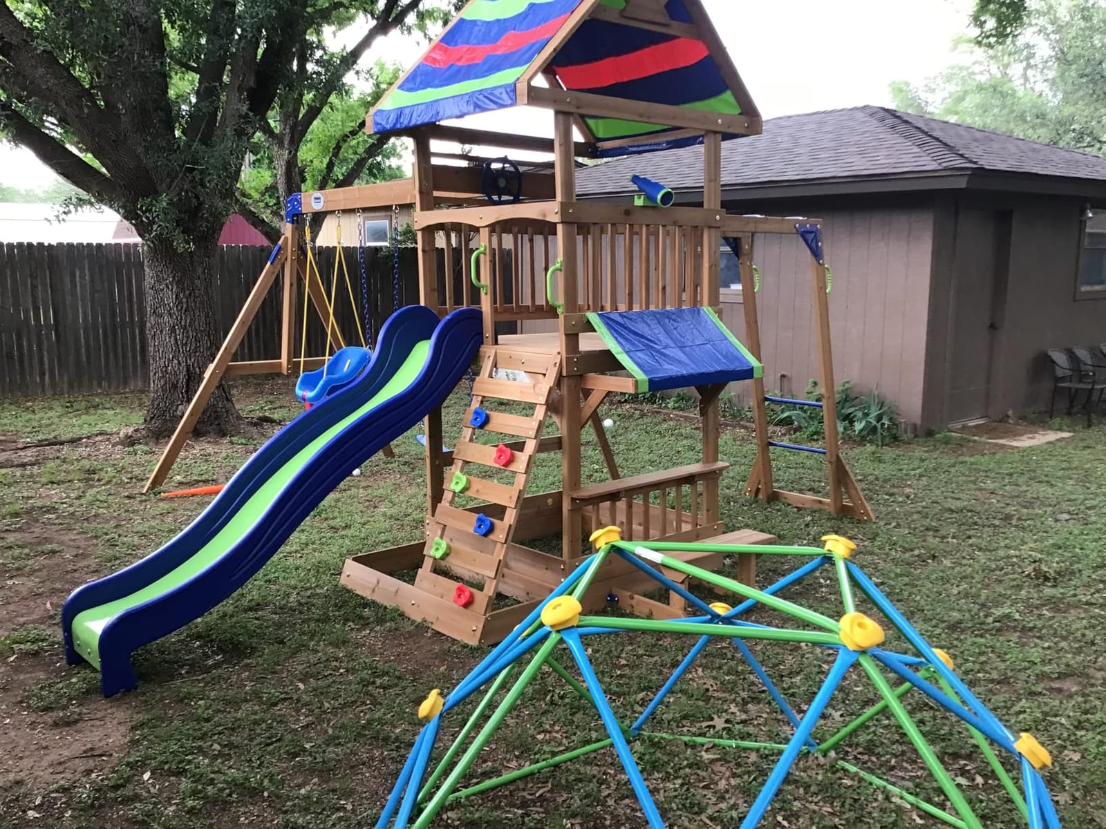Backyard Discovery Beach Front Cedar Wood Swing Set with Wave Slide, Play Deck, Monkey Bars, Rock Wall Ladder, Shaded Picnic Area, Snack Bar, Belt Swings, Trapeze, Sandbox Area, Outdoor Playset customer photo 2